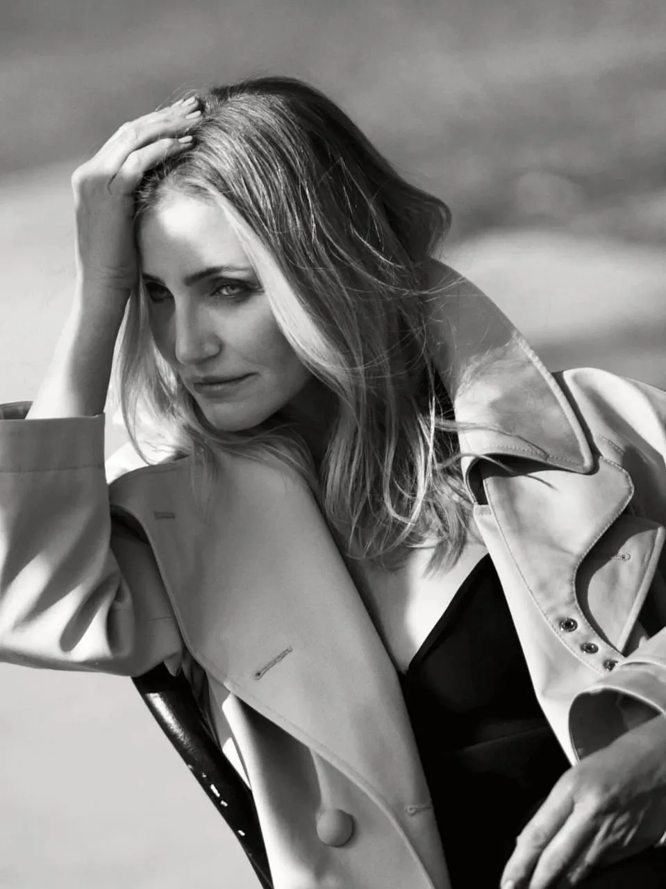 Black And White Photo of Woman Smiling And Touching Her Hair