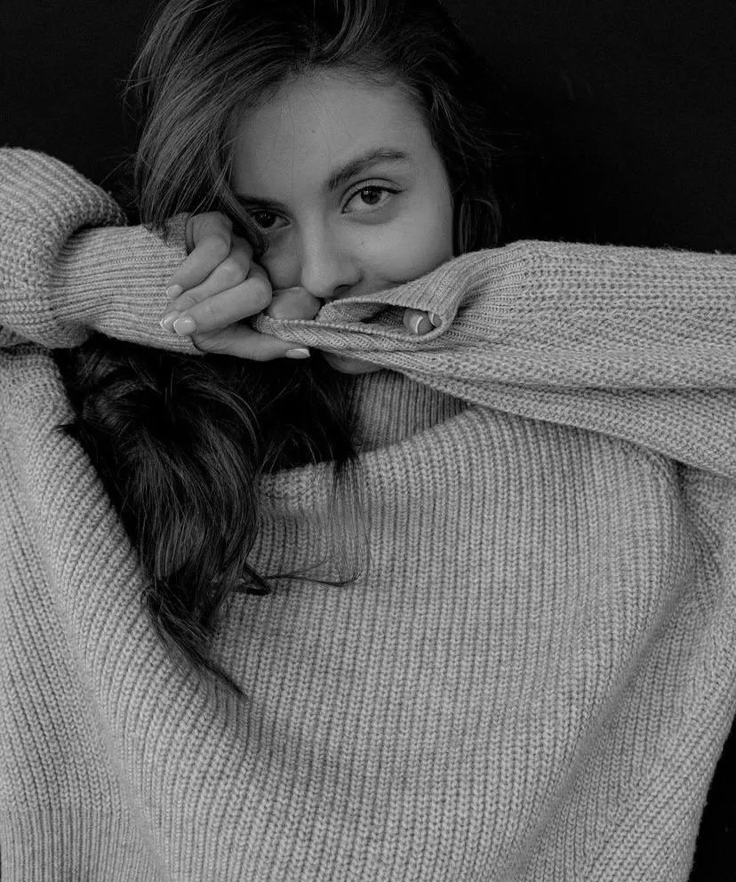 Black And White Portrait of a Woman Hiding Face with Sweater