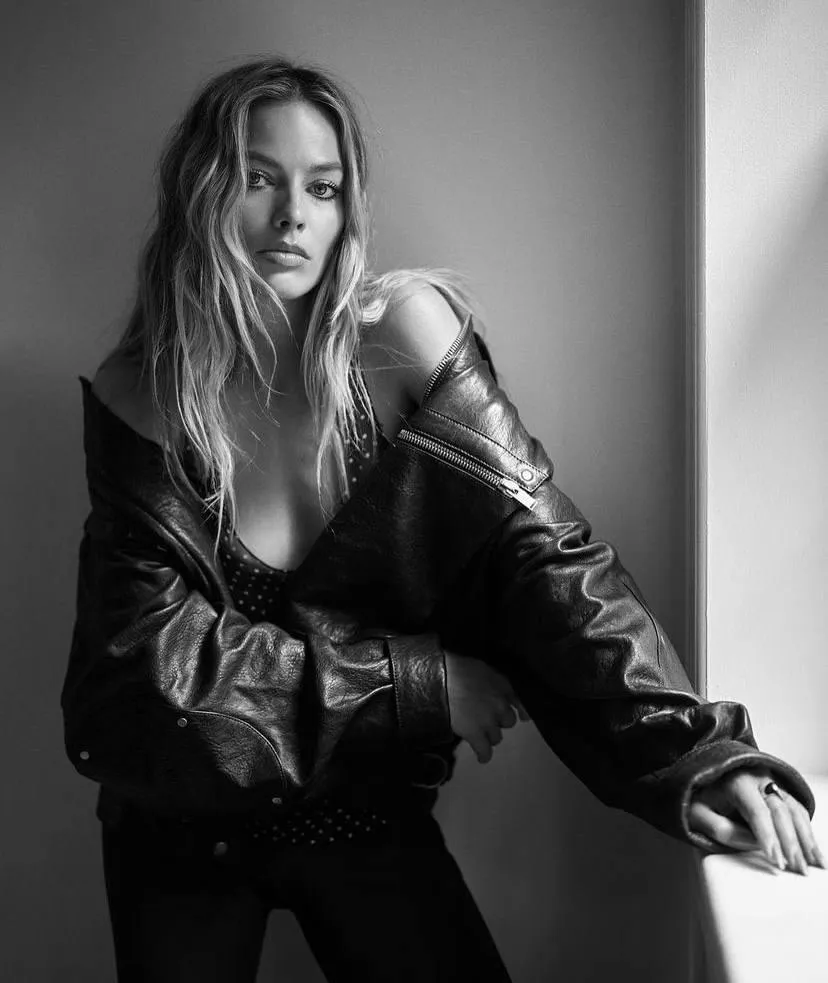 Black and white portrait of a woman in a leather jacket