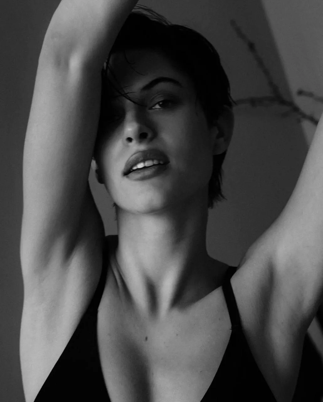 Black and white portrait of a woman raising both arms image