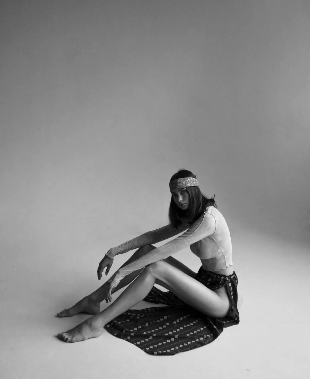Black And White Portrait of a Woman Sitting Cross Legged