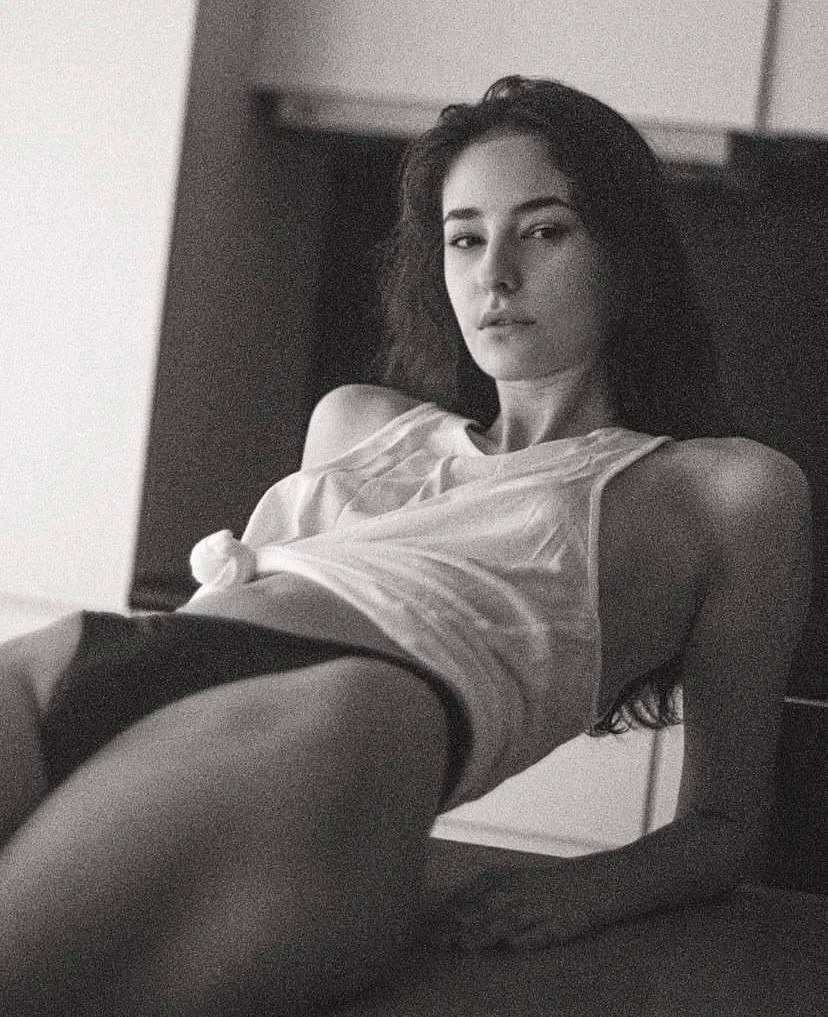 Black And White Portrait of a Woman Sitting on a Couch Image