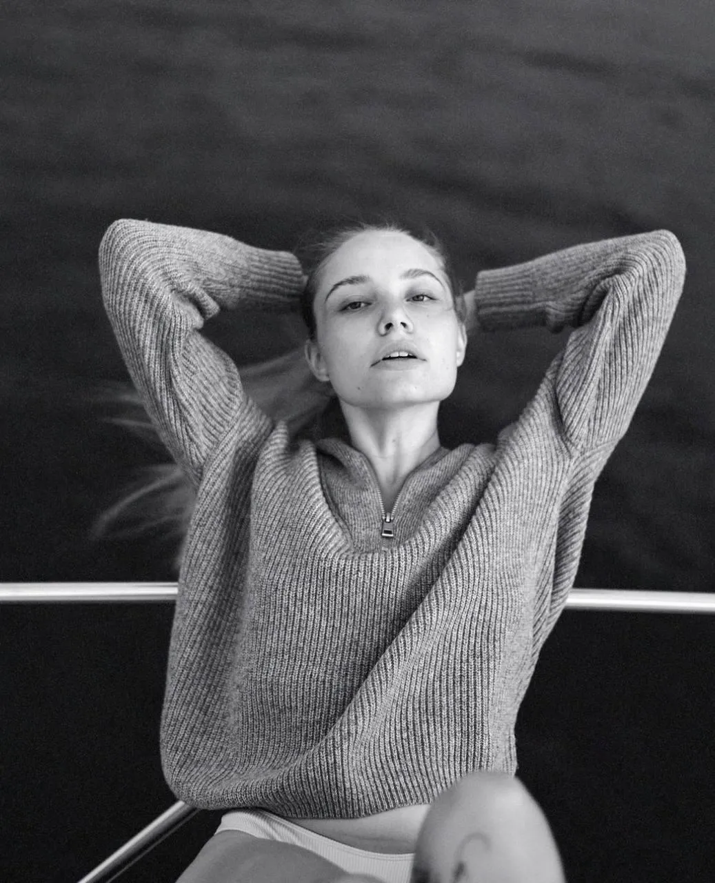 Black And White Shot of Relaxed Woman with Arms Behind Head