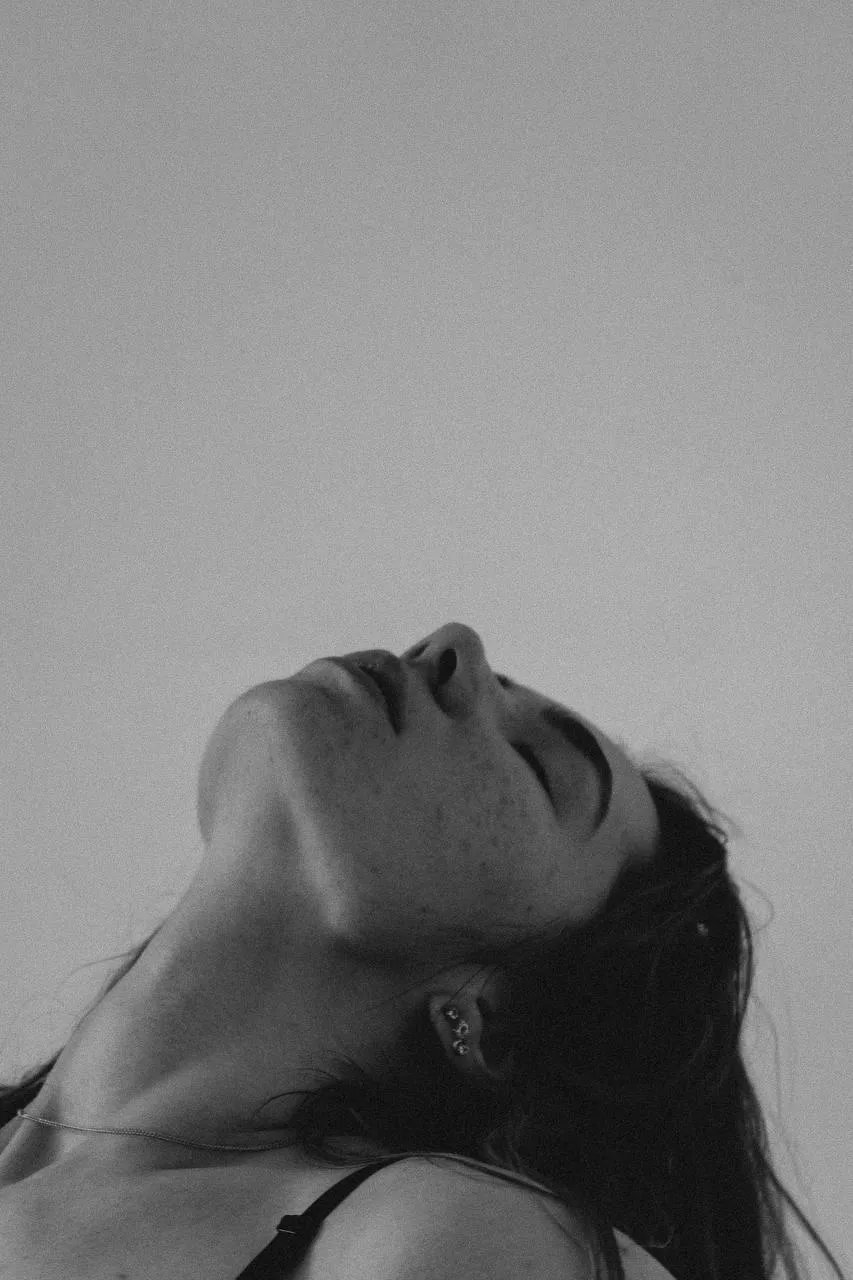 Black And White Side Profile of a Woman Tilting Her Head