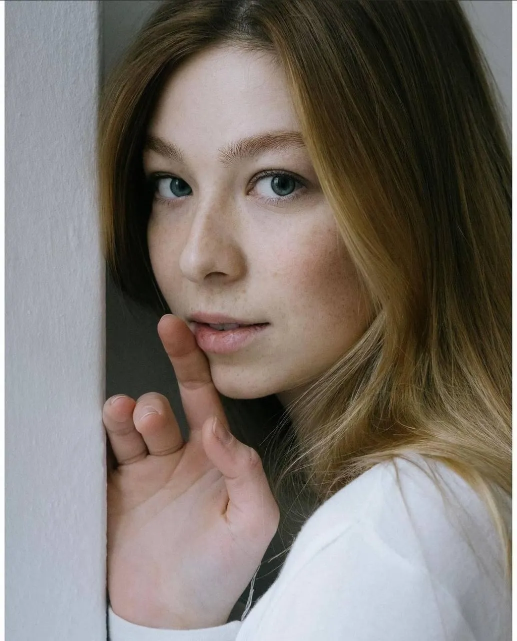 Blonde Woman in a White Shirt Looking Over Her Shoulder