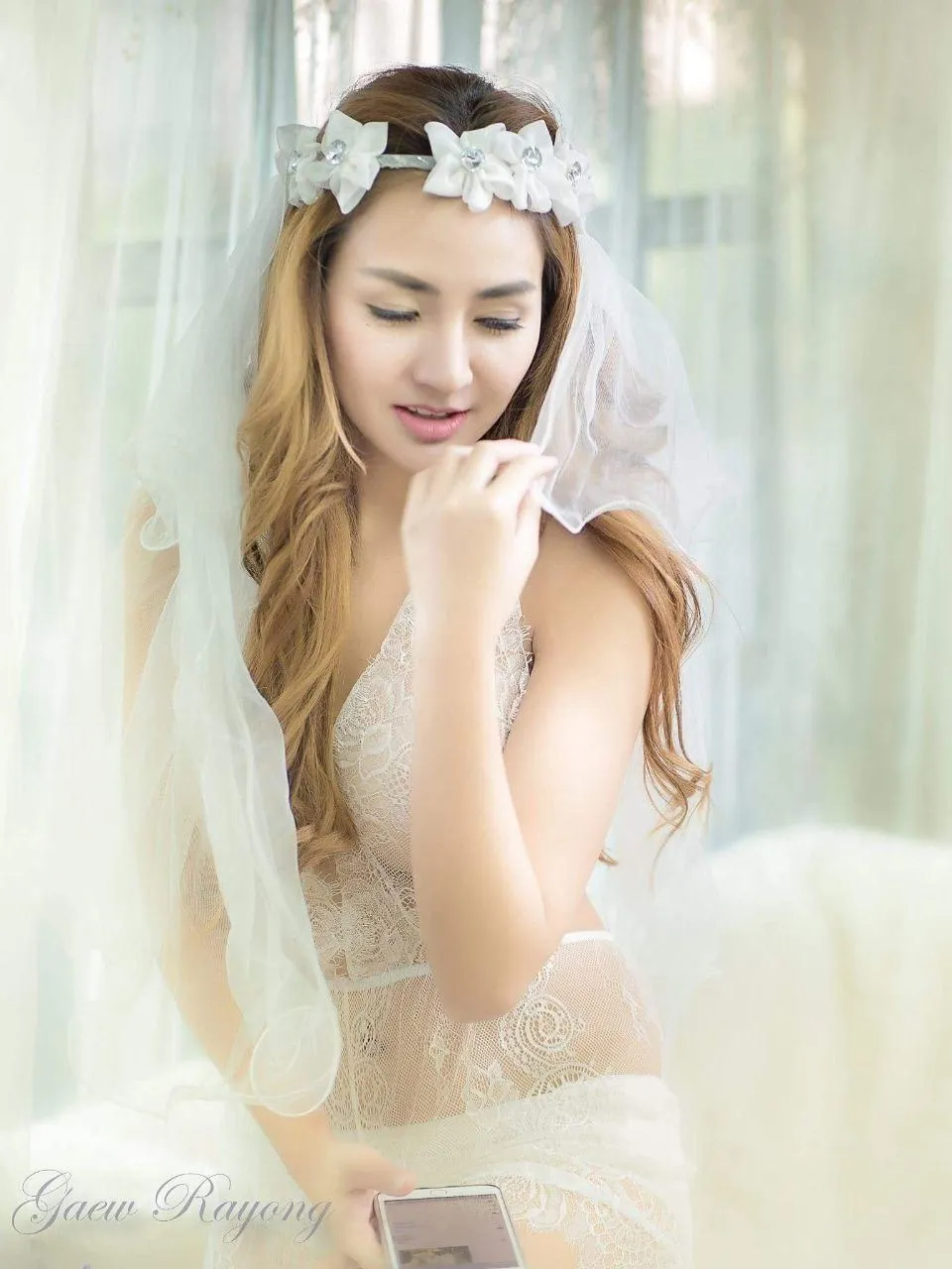 Bride in a White Gown And Tiara Smiling in Natural Light