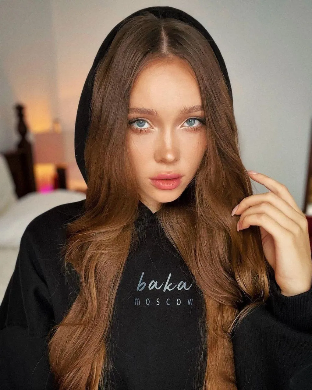 Brunette Woman in a Black Top Posing with Intense Soft Look