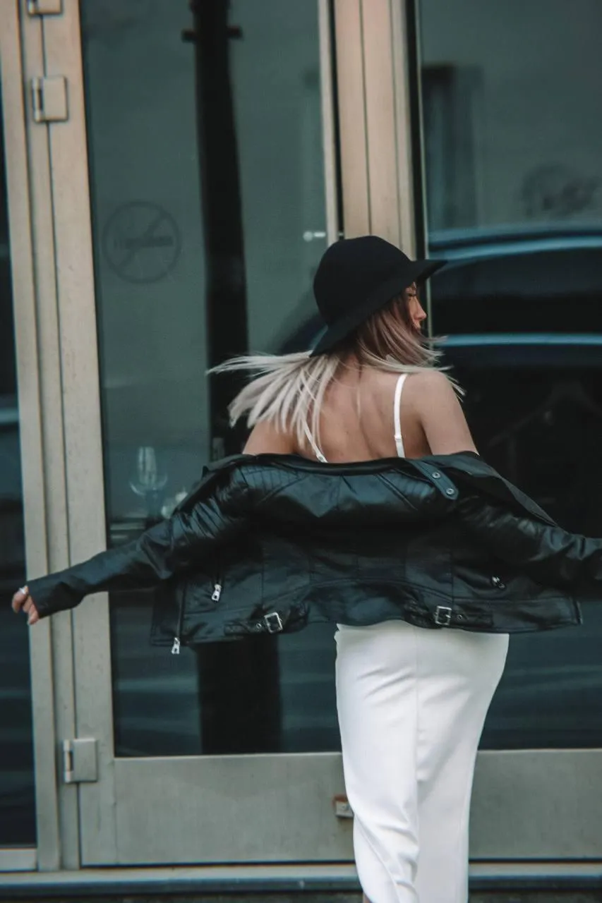 Candid photo of a woman in a black dress spinning in public