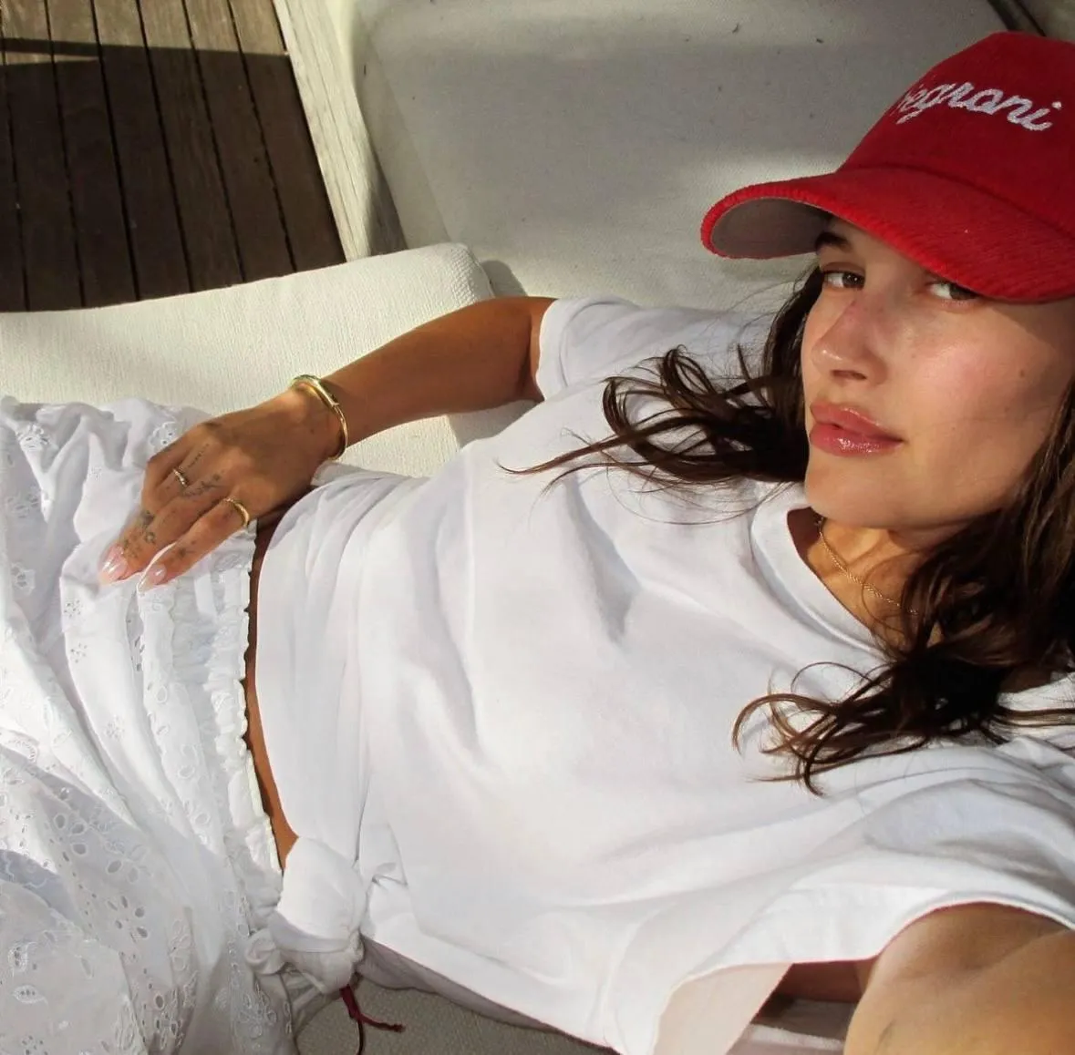 Casual Look with a Woman in a Cap Relaxing on a White Sofa