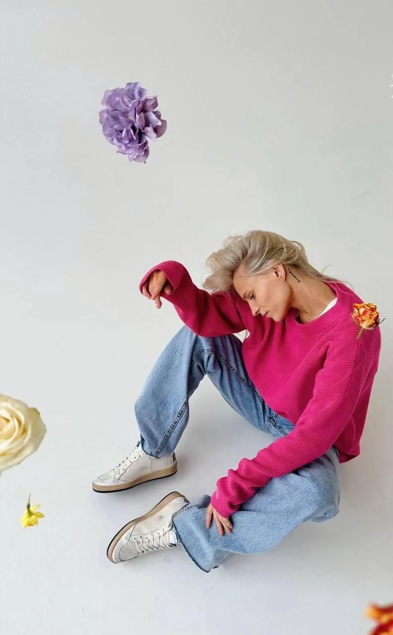 Casual portrait of person sitting on the floor with flowers