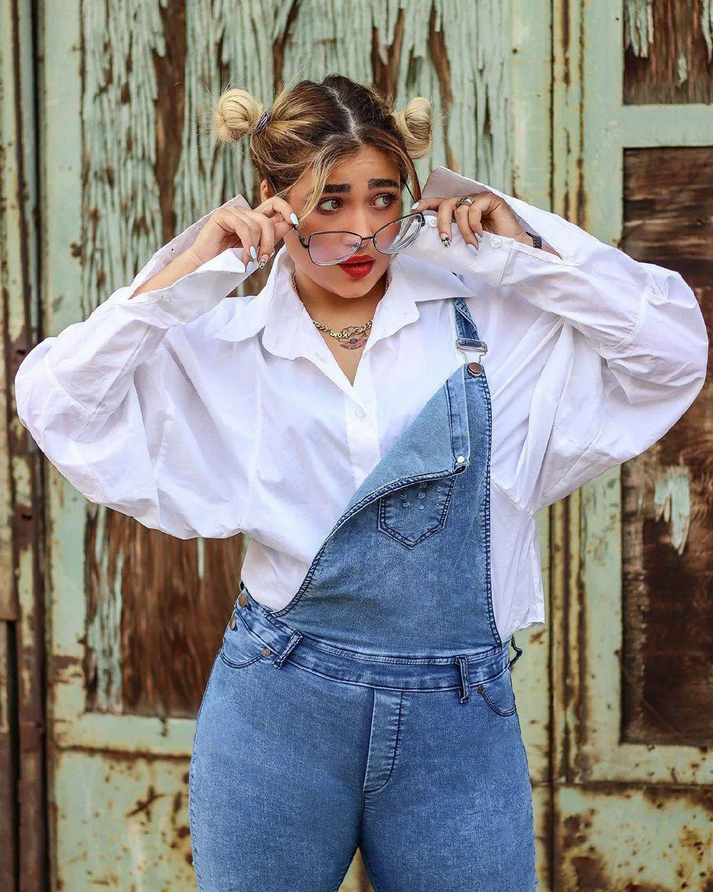 Casual Style Woman Posing in Overalls Making a Playful Face