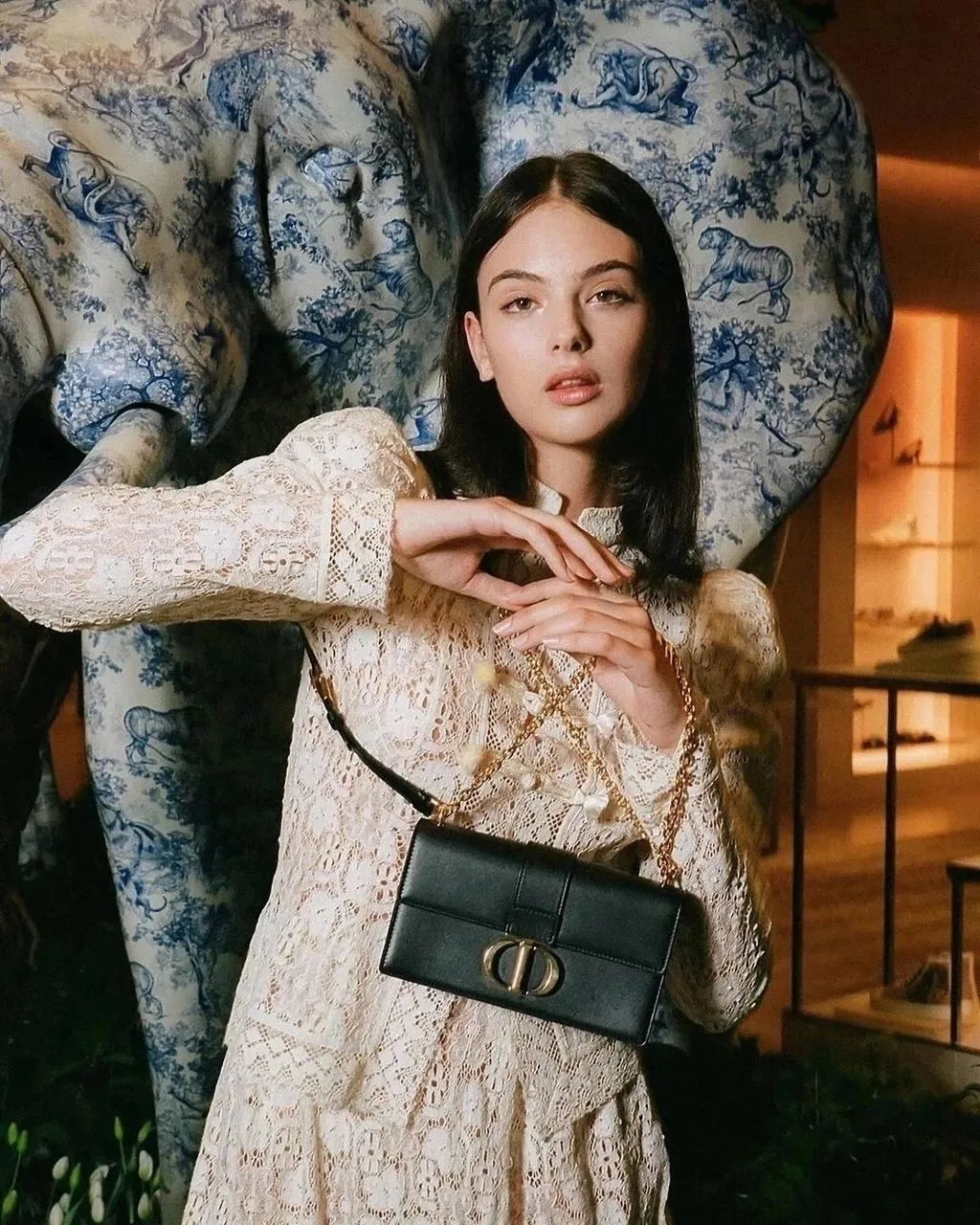 Chic Woman in a Lace Dress Beside a Giant Elephant Statue