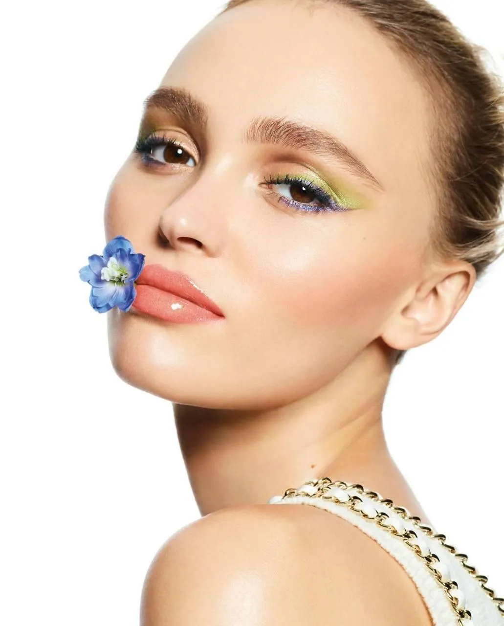 Close up of a woman with flower on her lips and fresh makeup