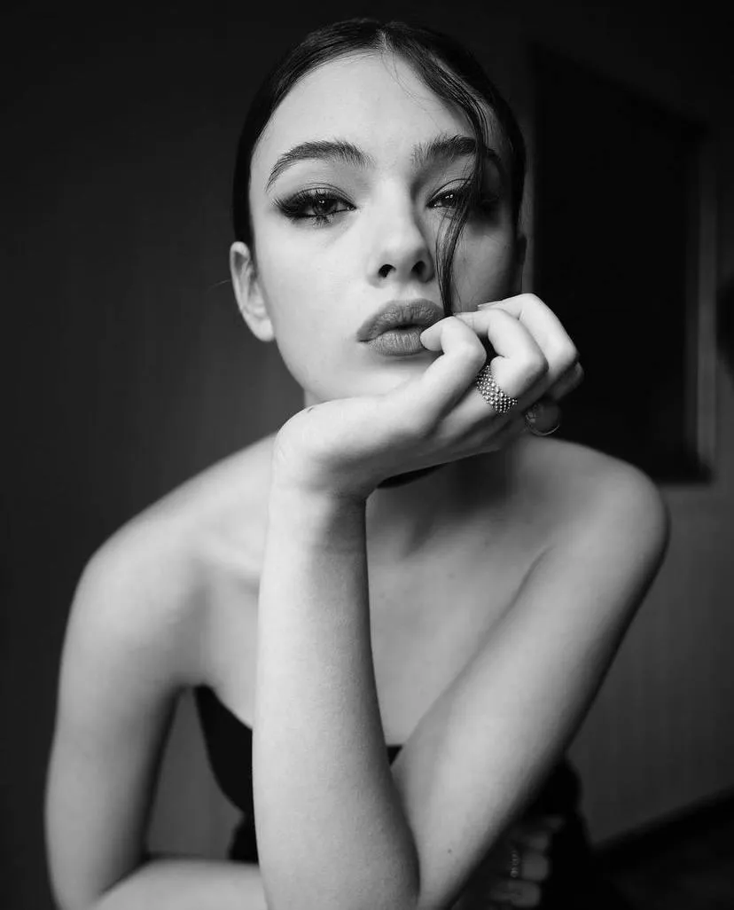 close up of a woman with her hand on her cheek wallpaper