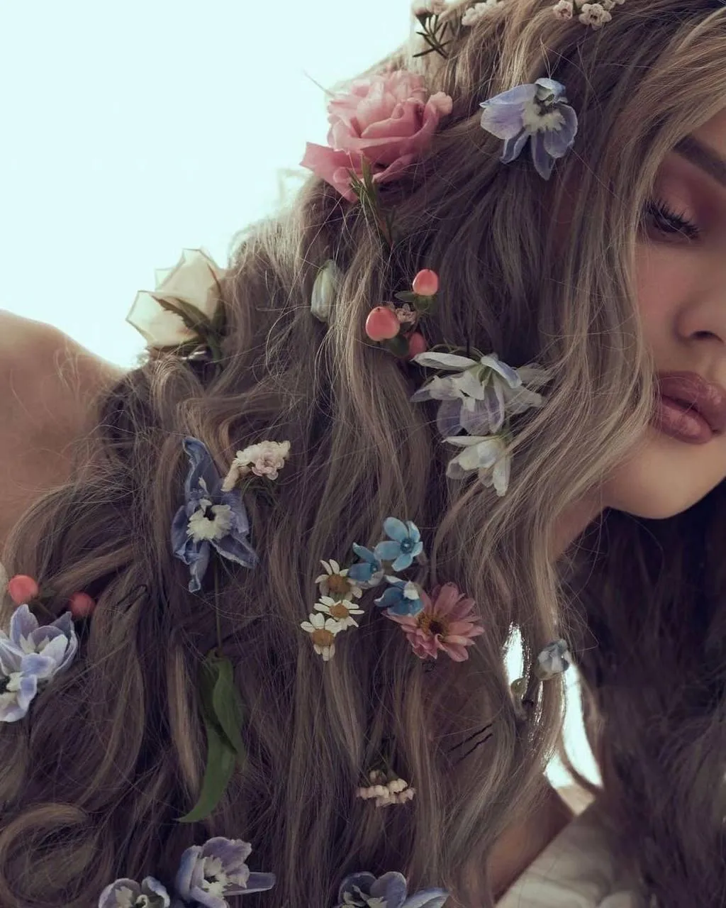 Close Up of a Woman with Long Hair Decorated with Flowers