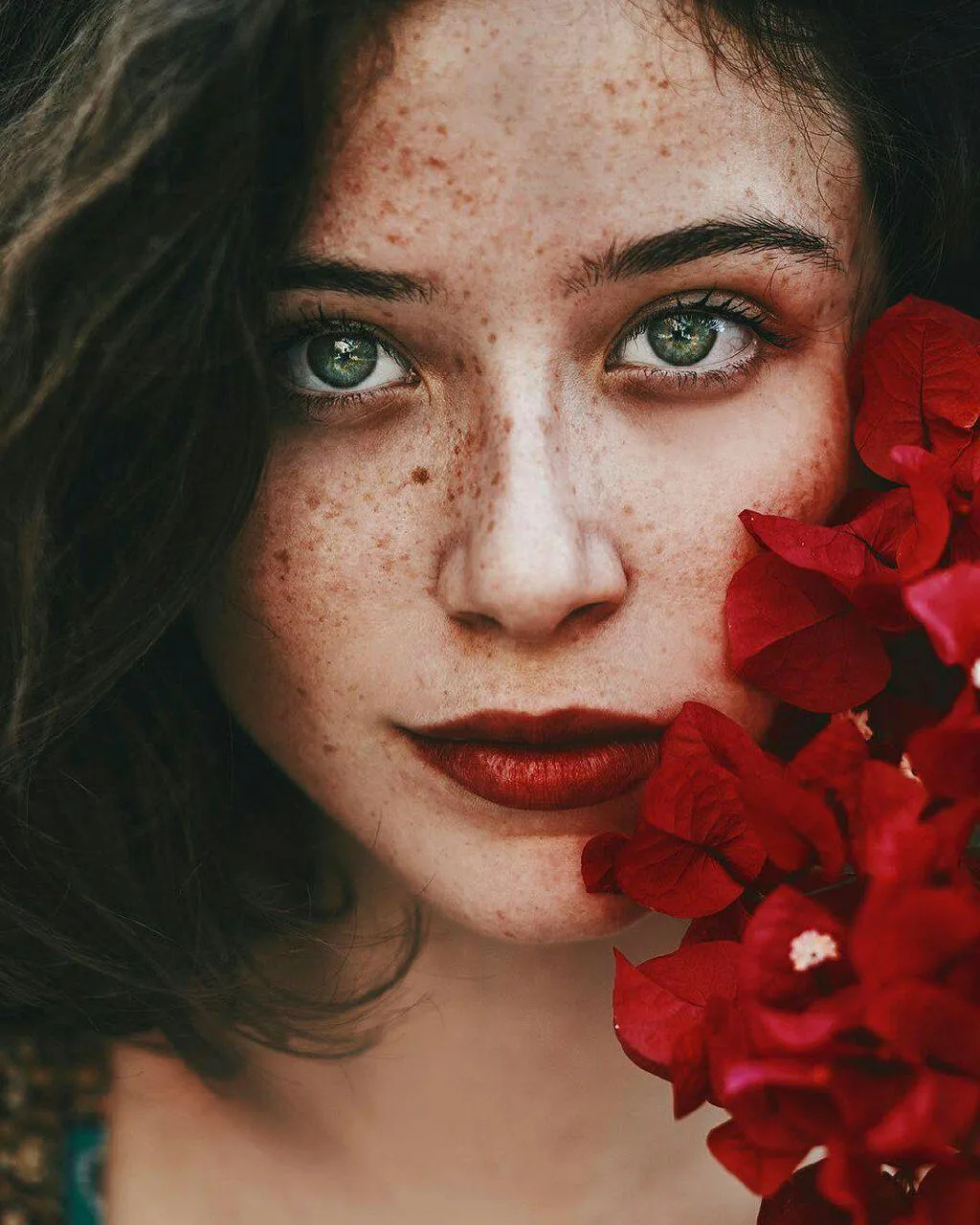 Close Up of a Woman with Red Lips And Vibrant Red Flowers