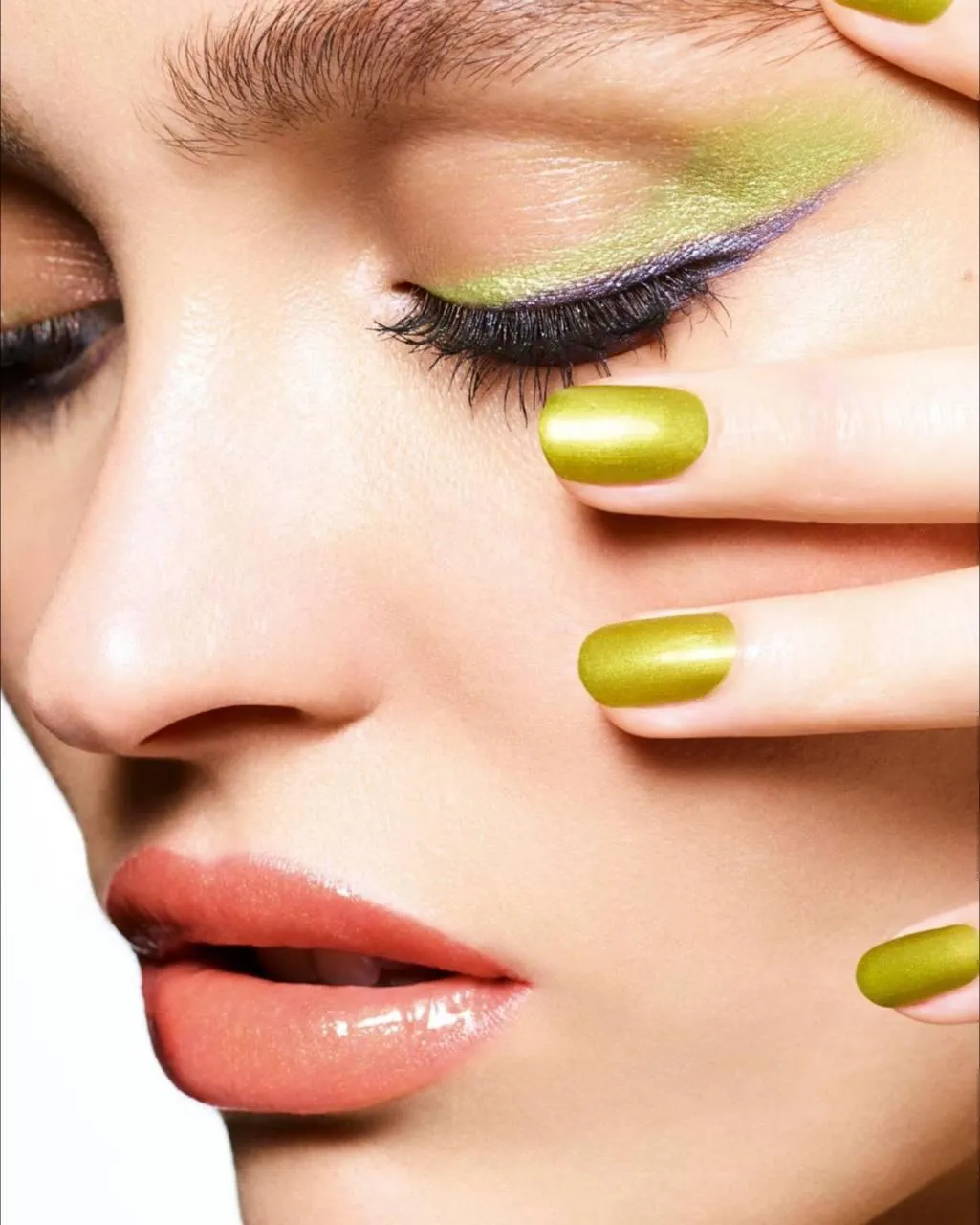 Close Up of a Womans Face with Bold Green Nail Polish Image
