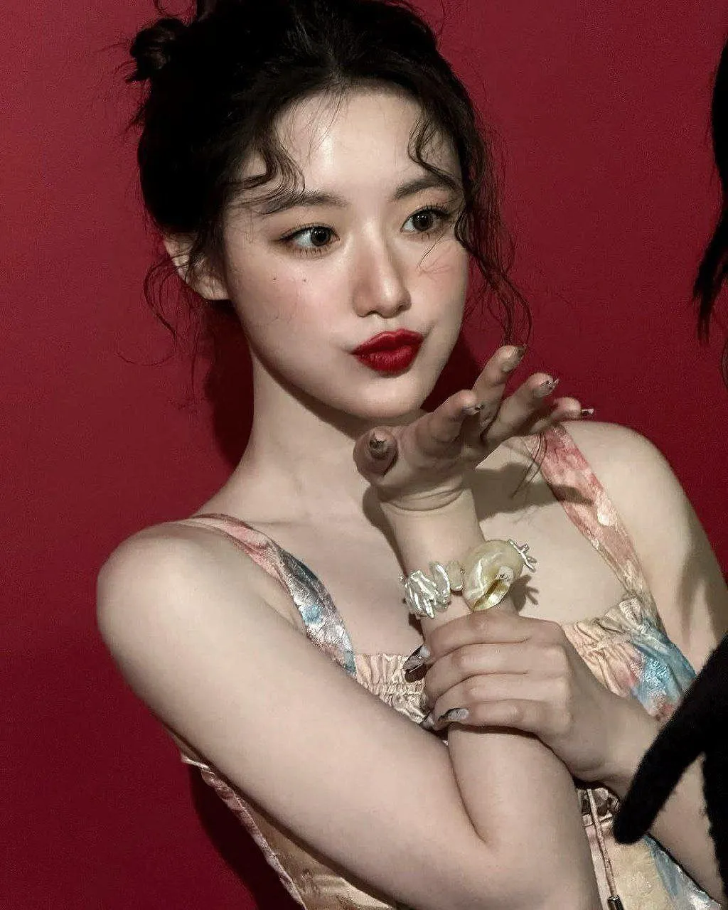 Close Up of Woman with Red Lipstick Posing Against Red Wall