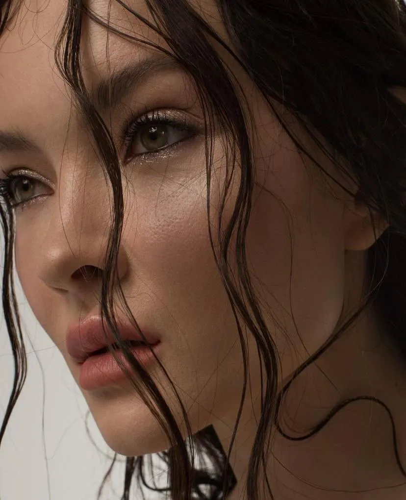 Close up of womans face with wet hair and soft lighting