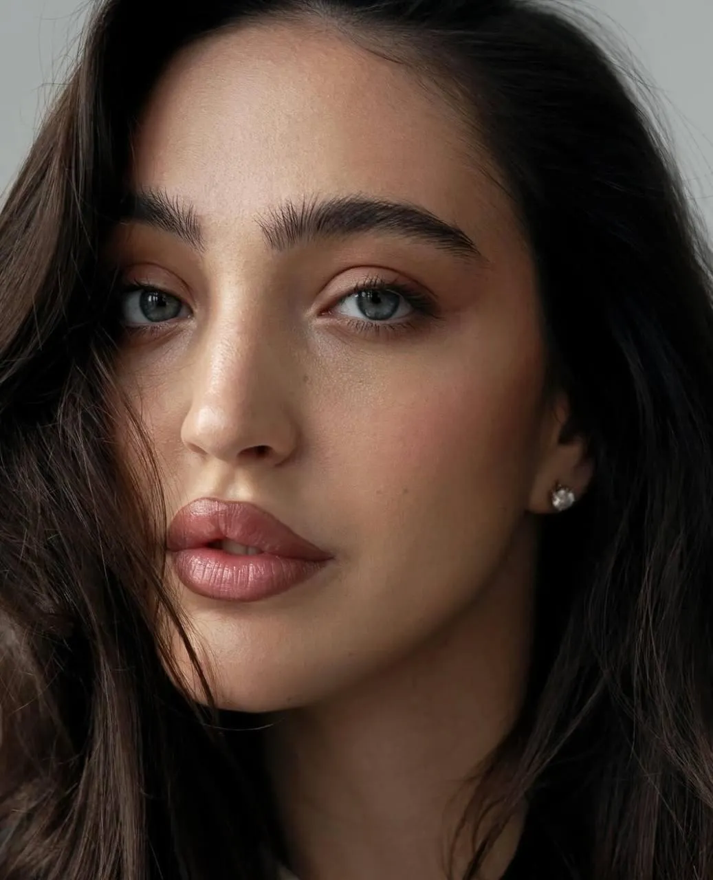 Close Up Portrait of a Brunette Woman with Makeup And Curls