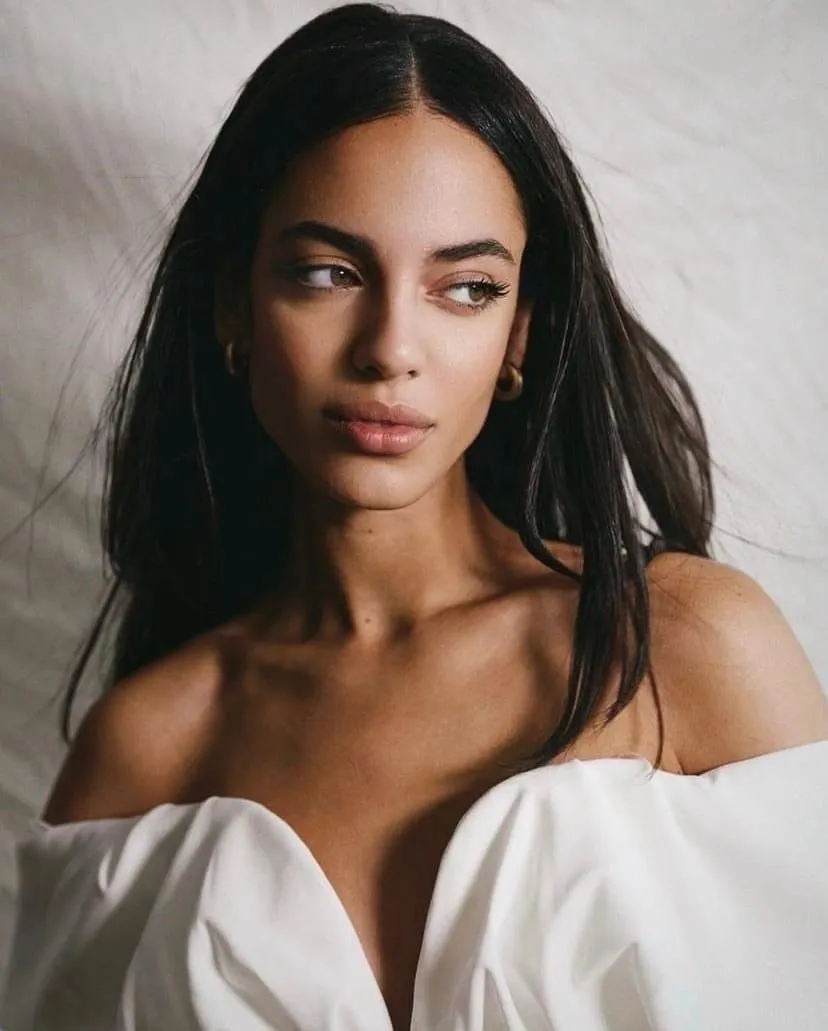Close up portrait of a woman in a white off shoulder top