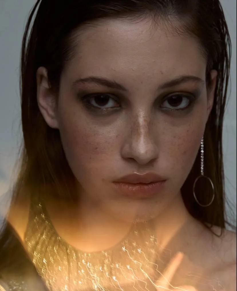 Close up portrait of a woman with earrings and natural glow