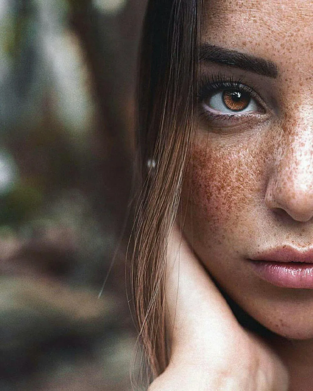 Close Up Portrait of a Woman with Freckles And Soft Gaze