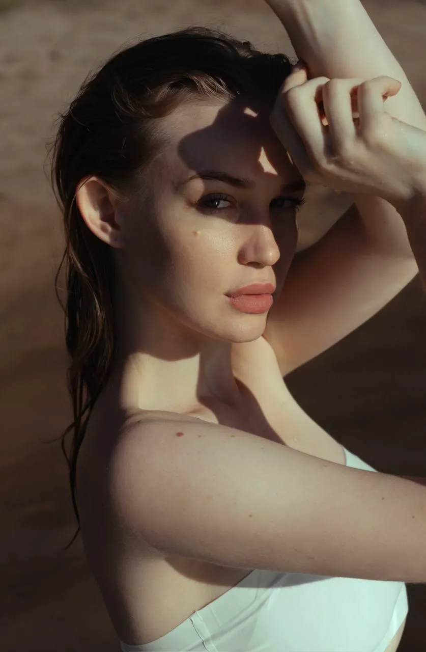 Close up portrait of a woman with her hand covering her face