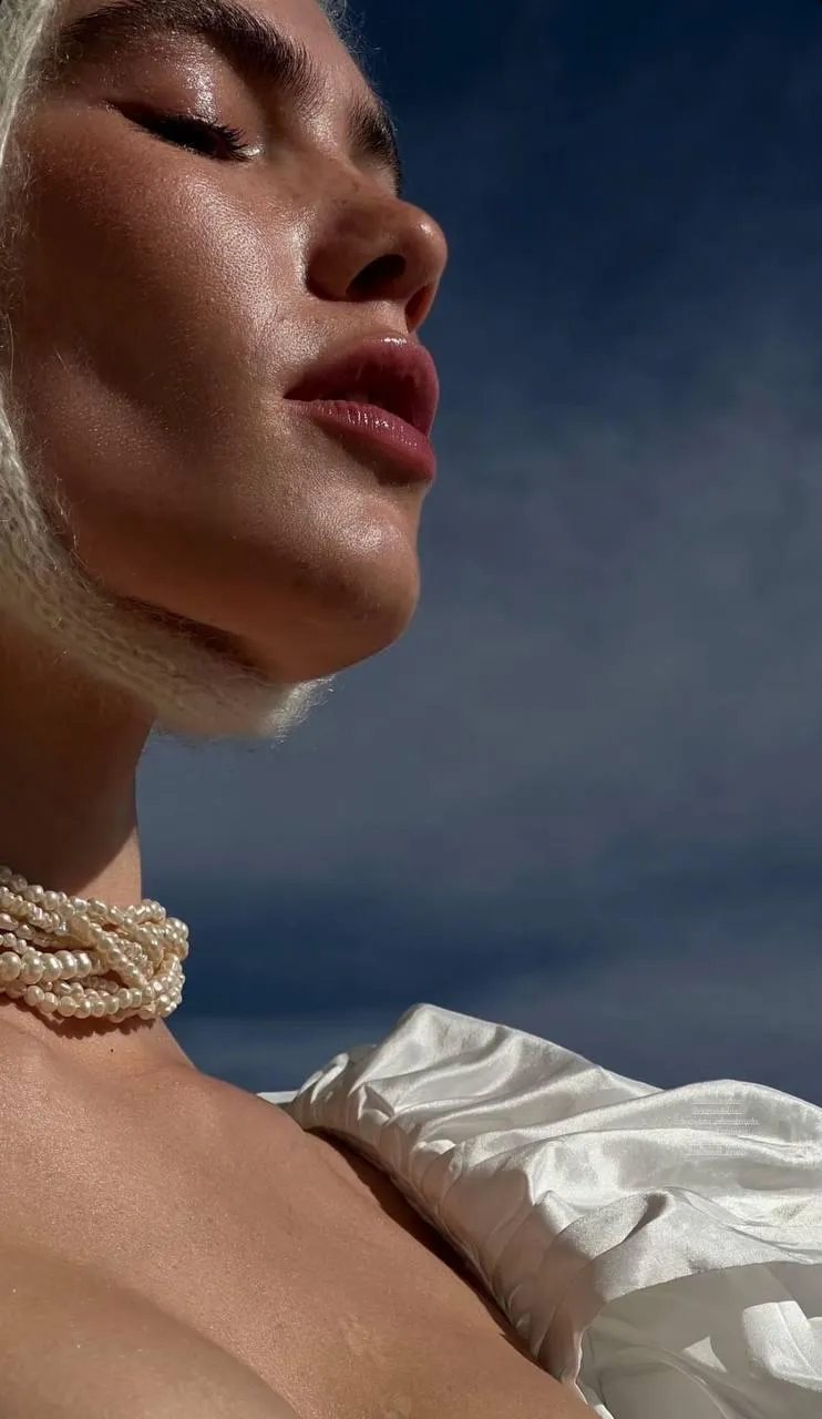 Close up profile of a woman outdoors with a necklace image