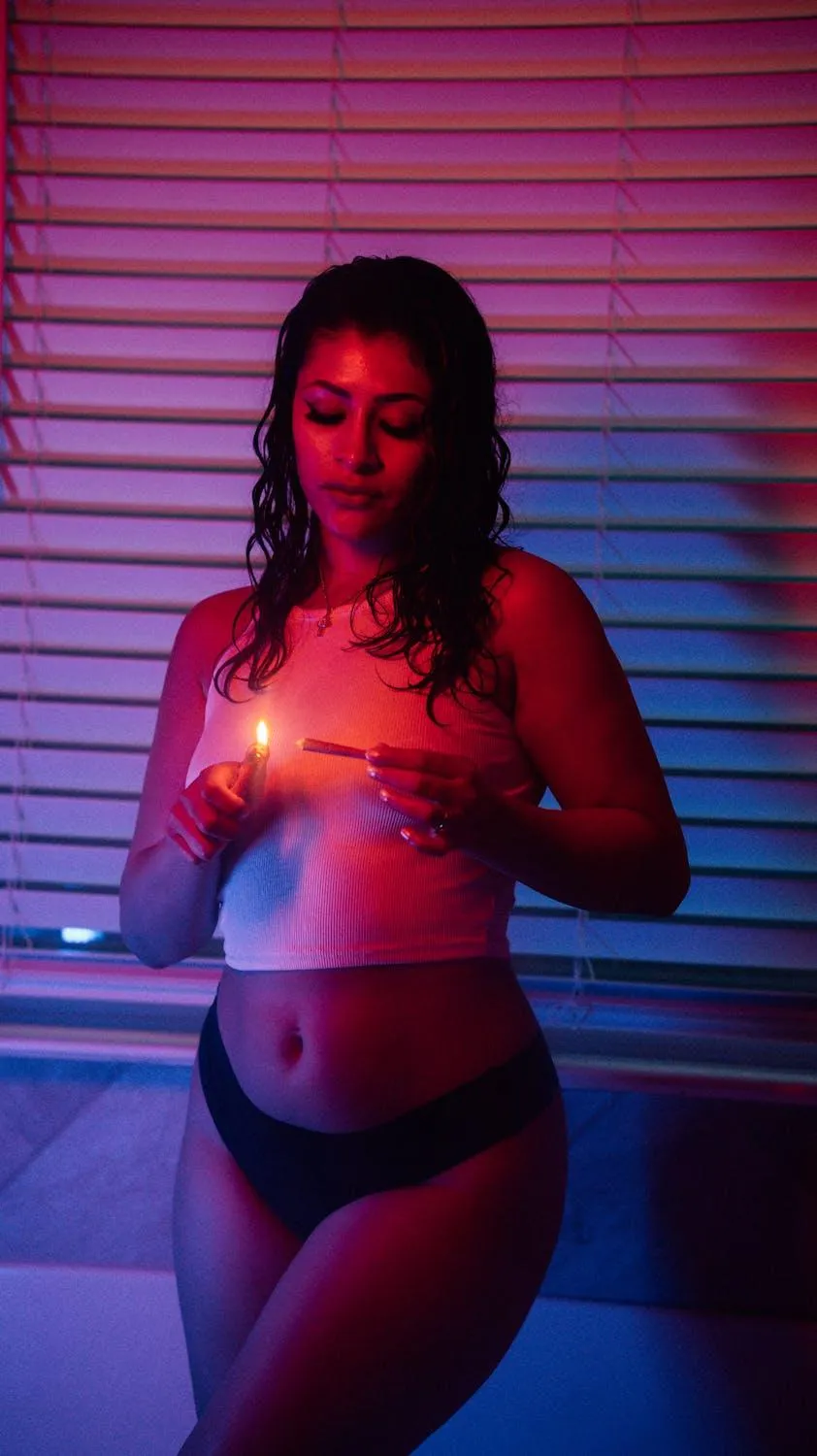 Colorful Lighting on a Woman in Lingerie Standing Indoors