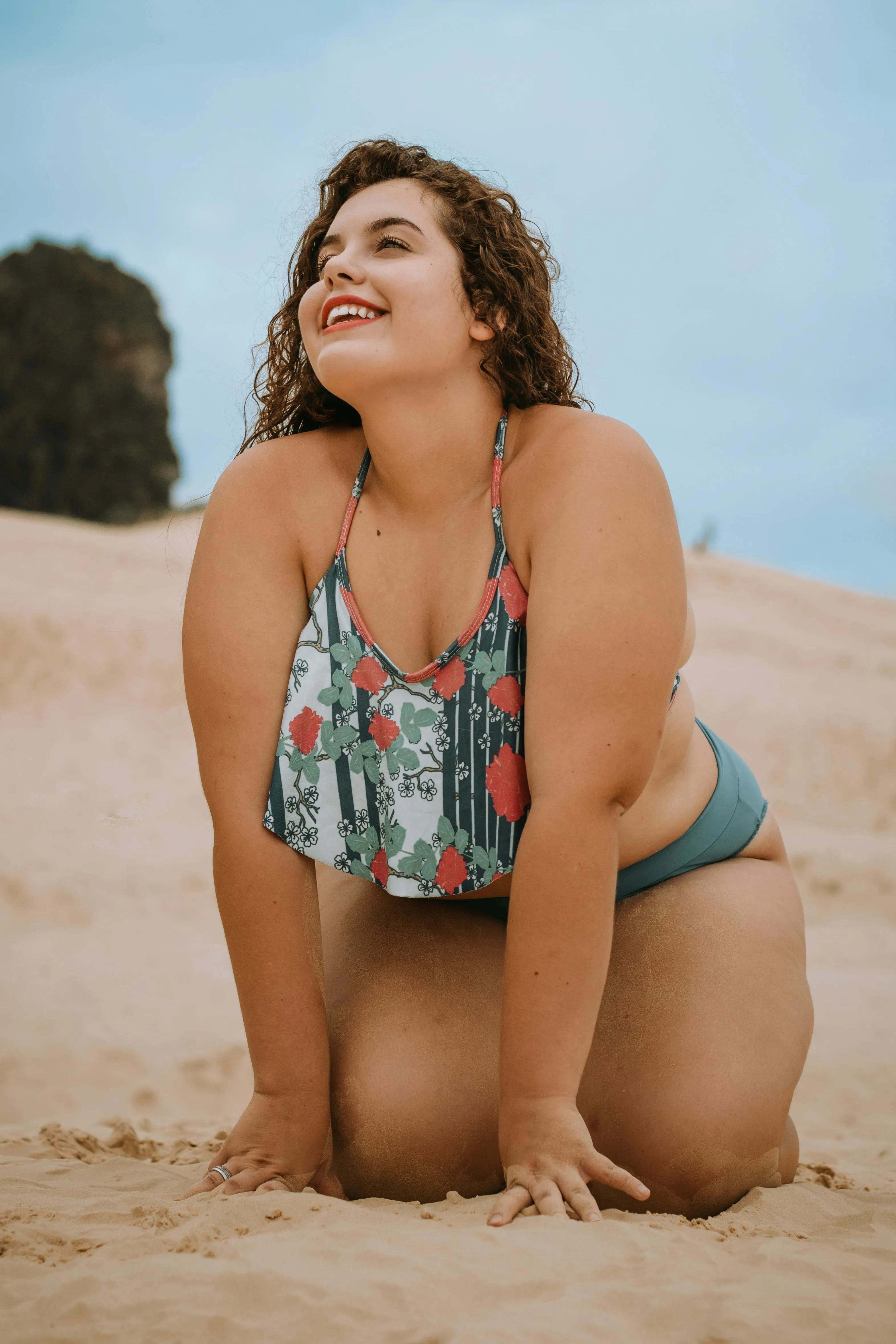 Confident Curvy Woman Smiling Brightly on a Sandy Beach