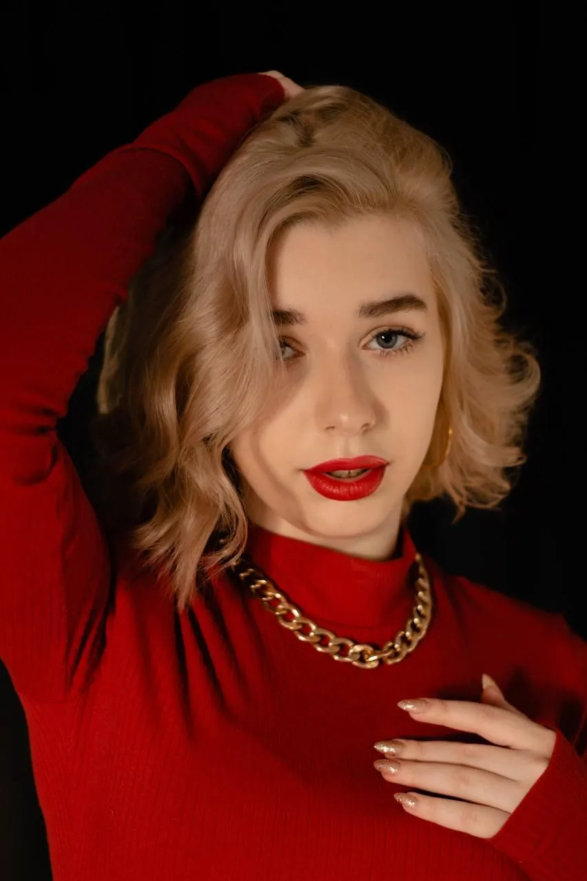 Confident woman in a red sweater with hand behind her head