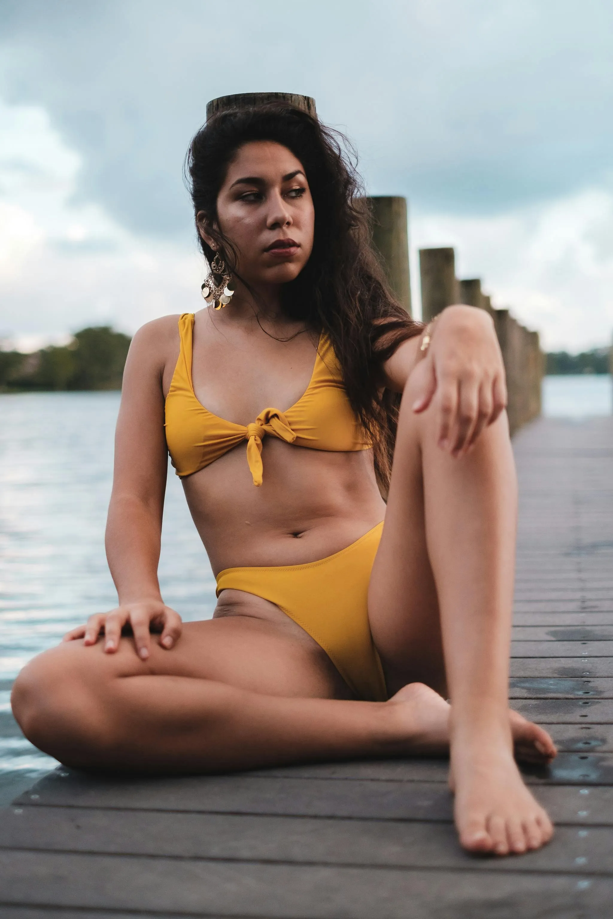 Confident Woman in a Yellow Bikini by a Waterfront City