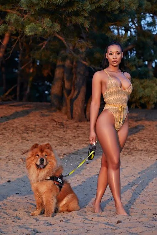 Confident woman in a yellow outfit standing beside her dog