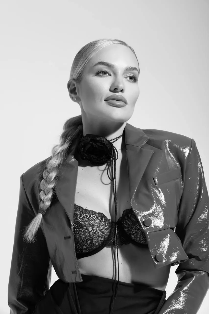 Confident Woman Posing in a Black Leather Jacket Wallpaper