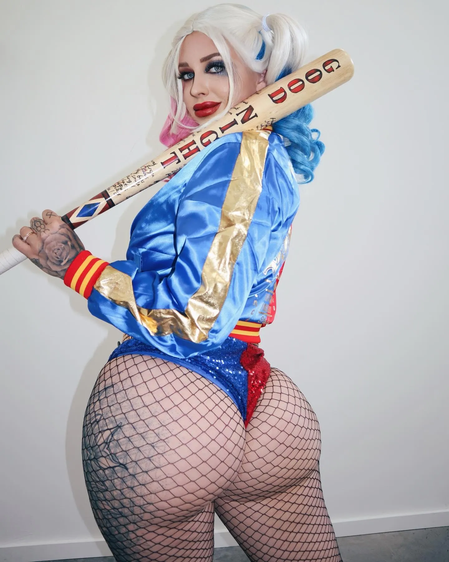 Cosplay Model in a Colorful Outfit Holding a Baseball Bat