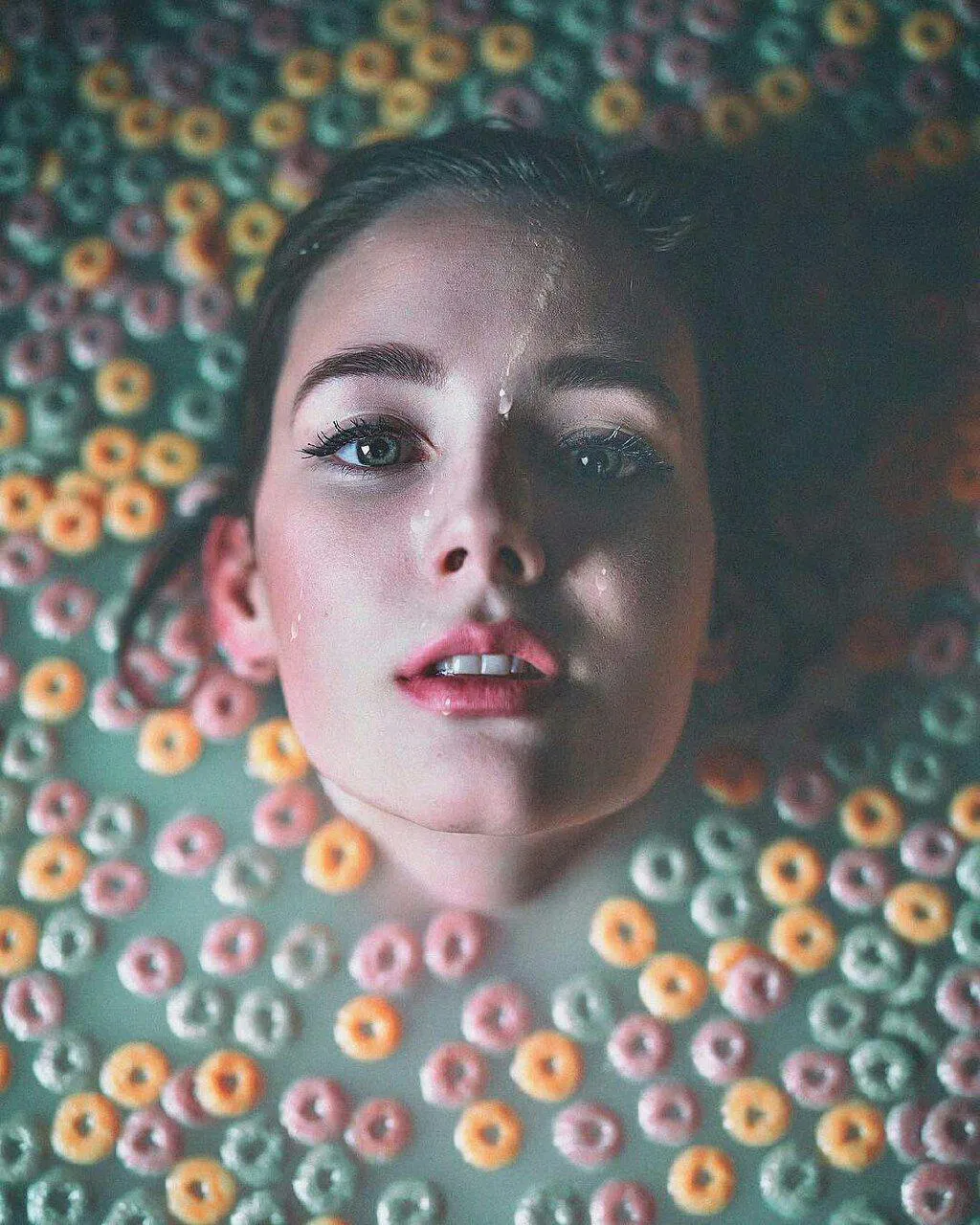 Creative Portrait of a Woman Surrounded by Cereal Rings