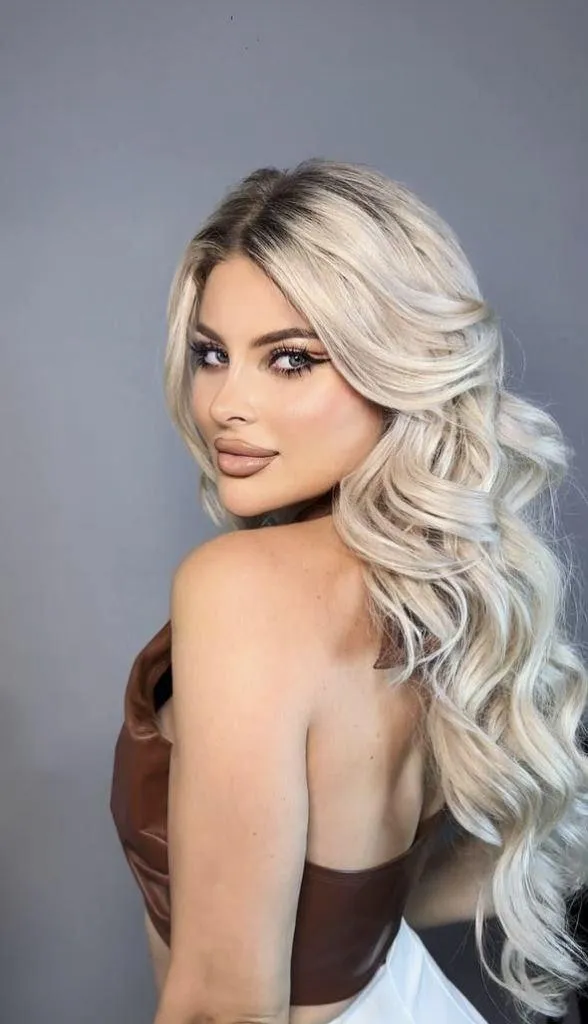 Cute model with a black top and long hair looking back image