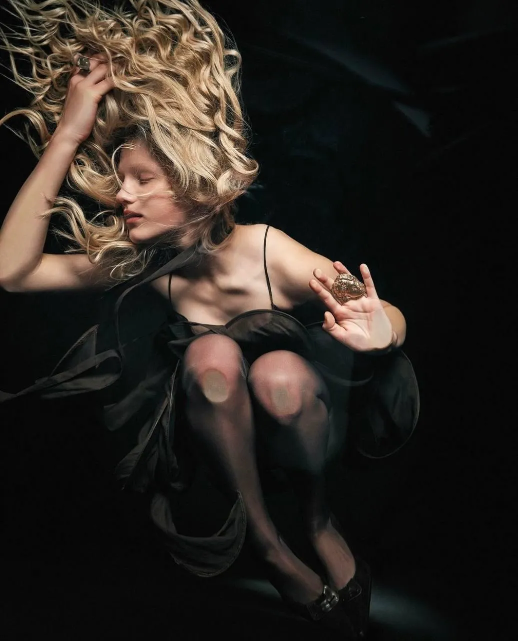 Dramatic Photo of a Woman with Flowing Hair in a Black Dress