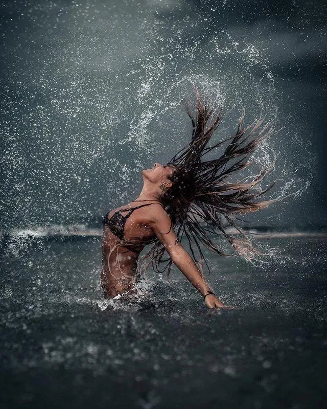 Dynamic Splash Portrait of a Woman Flipping Wet Hair Image