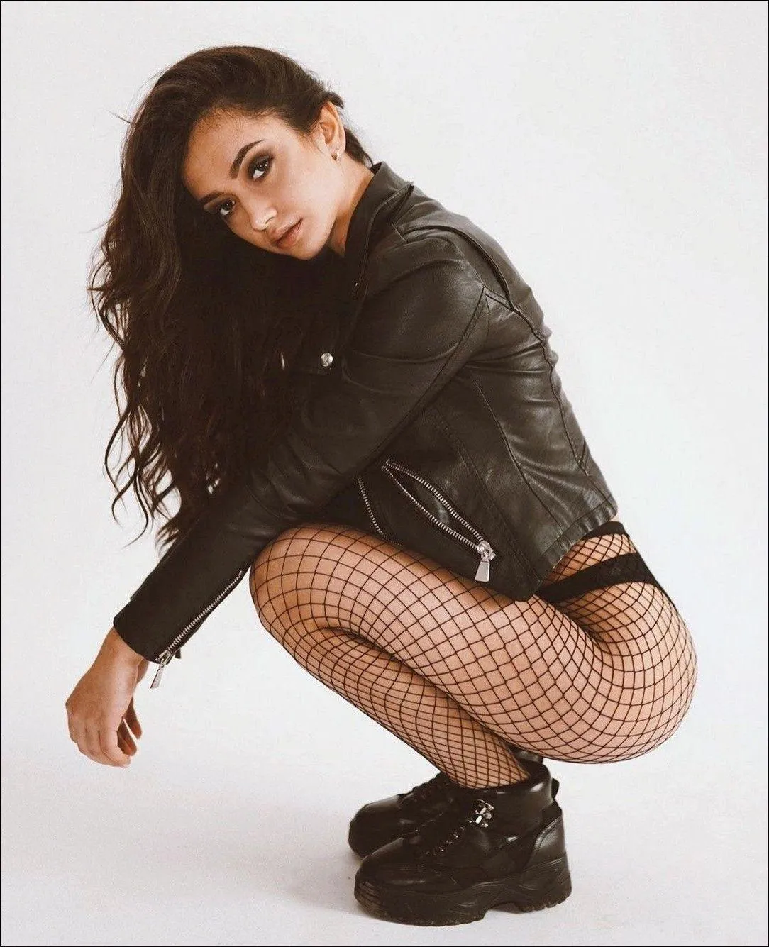 Edgy Fashion Portrait with a Leather Jacket And Fishnets
