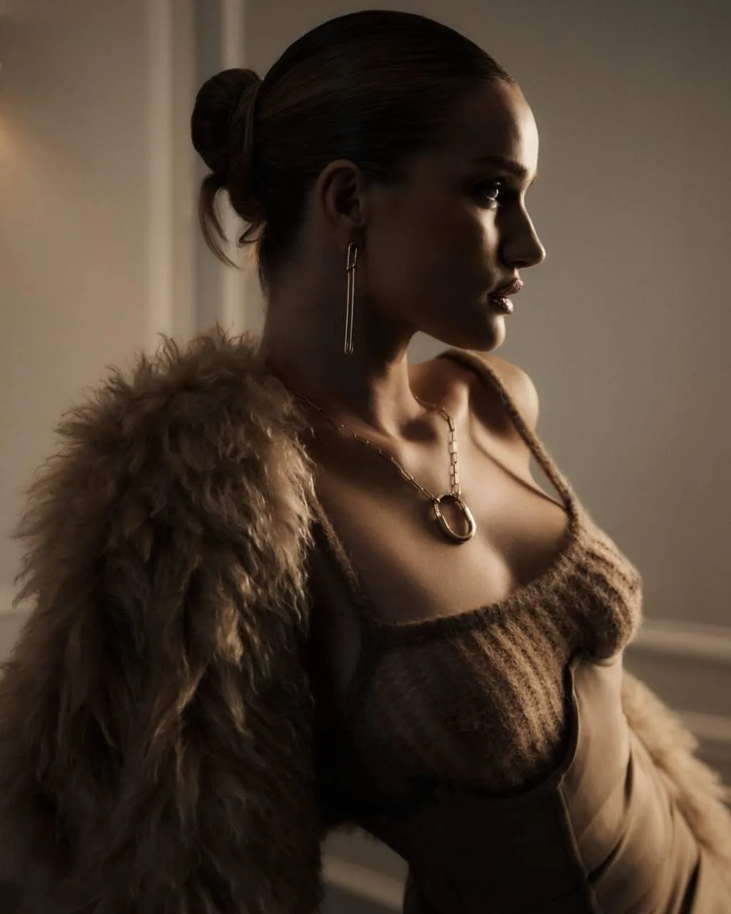 Elegant profile of a woman in fur and necklace in warm light
