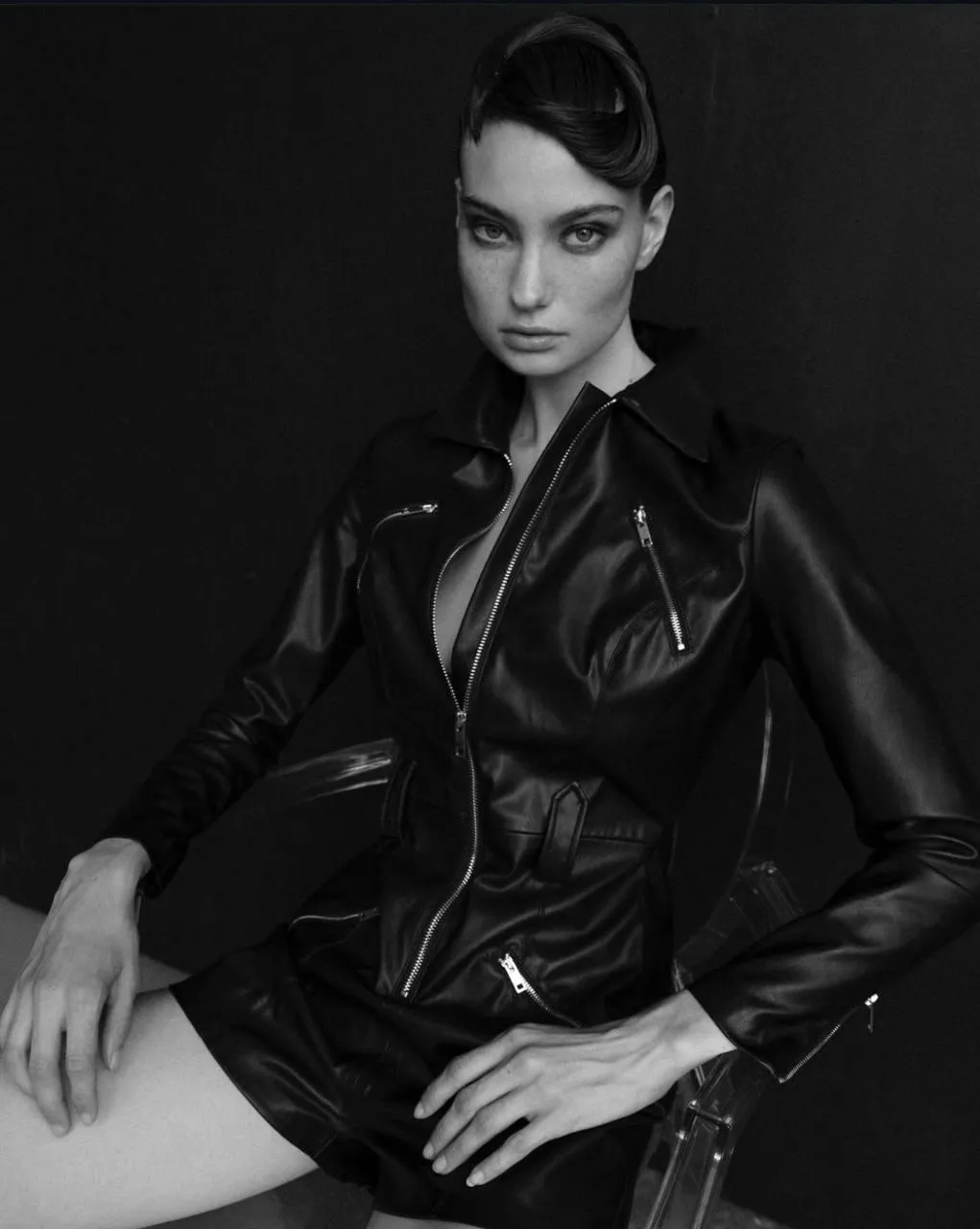 Elegant woman in a black leather jacket with sleek hairstyle