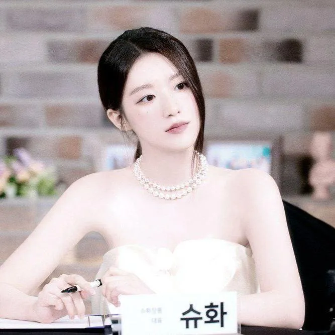 Elegant woman in a white gown sitting gracefully indoors