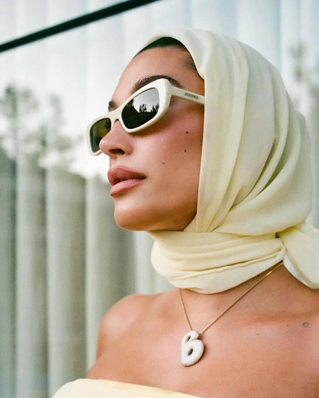 Elegant Woman in Sunglasses And a Scarf Looking Aside Image