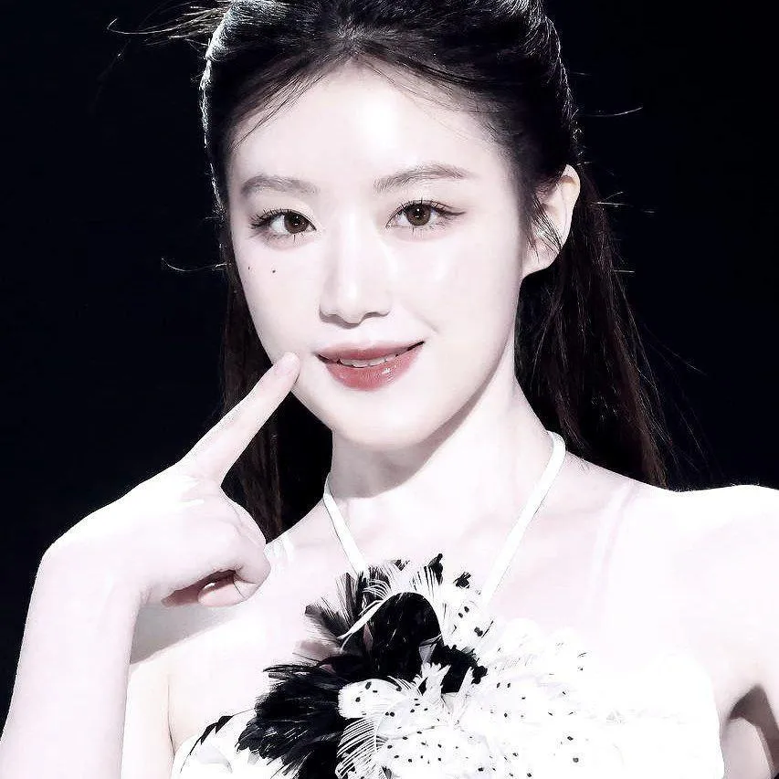 Elegant woman in white and black floral dress smiling gently