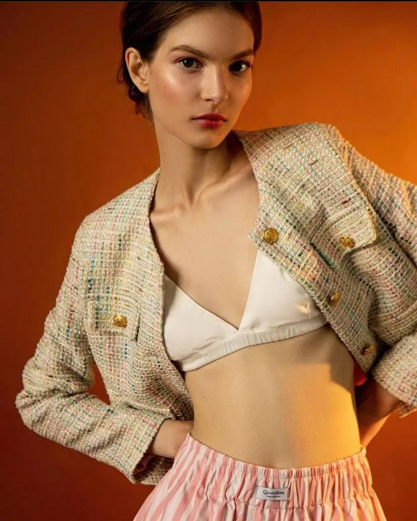 Fashion Model in a Cropped Jacket Posing on Orange Backdrop