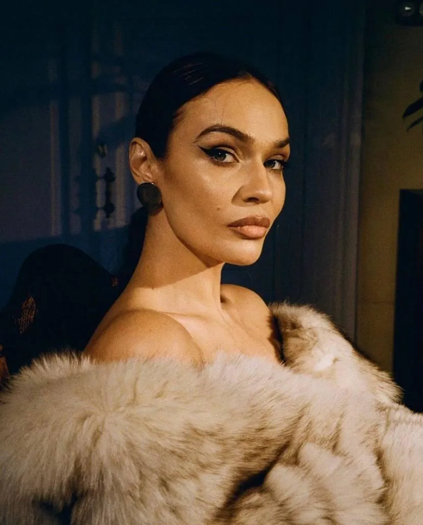 Fashion model in a fur wrap looking over her shoulder boldly