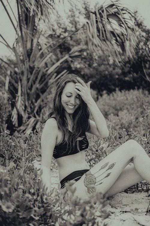 Fashion model sitting outdoors in a natural scenic setting
