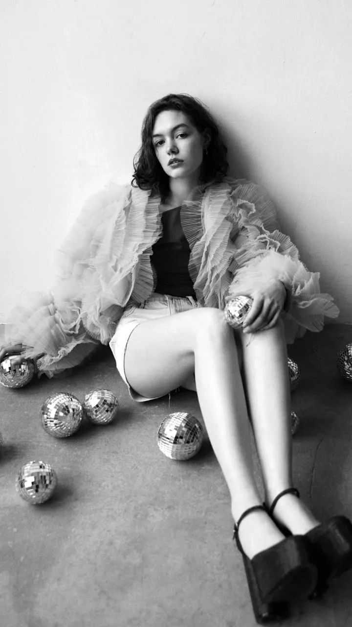 Fashion model sitting with ornaments and winter clothing